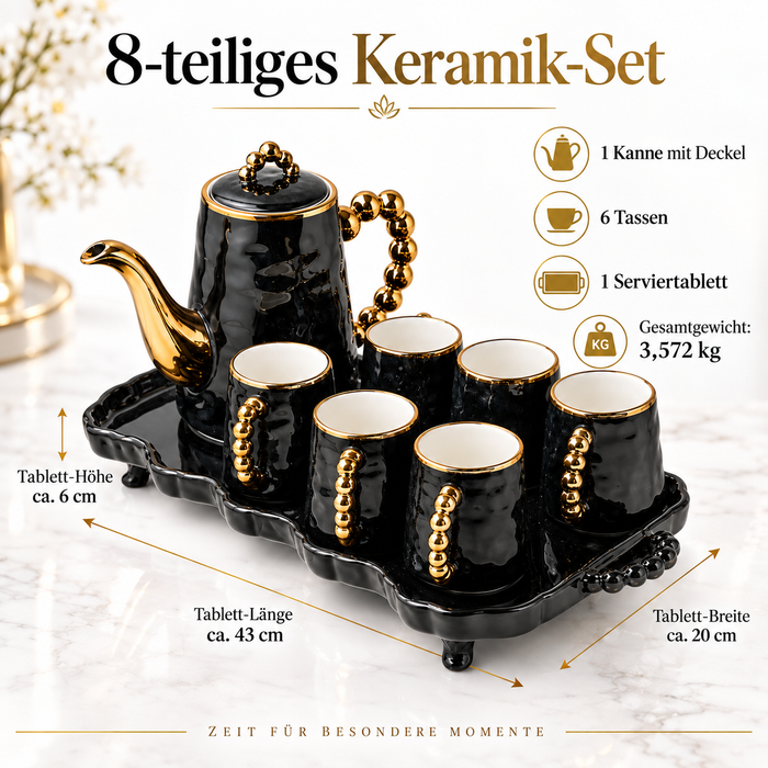 Schwarze Keramikkanne mit goldfarbenem Ausguss und Perlenhenkel